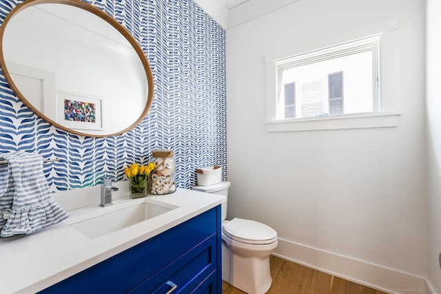 bathroom featuring hardwood / wood-style flooring, vanity, and toilet