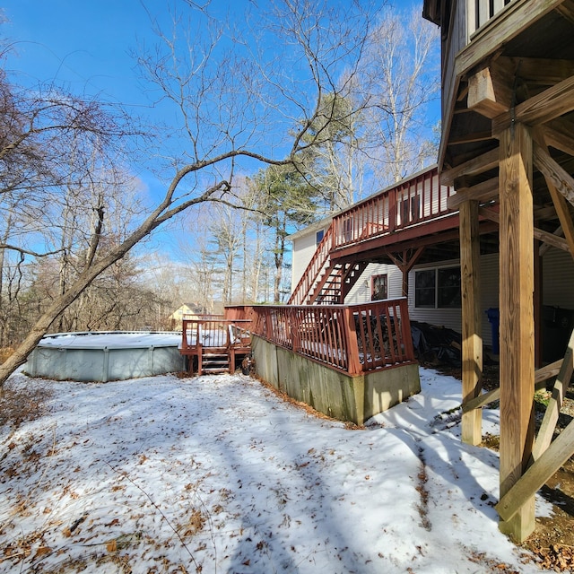 snowy yard featuring a swimming pool side deck