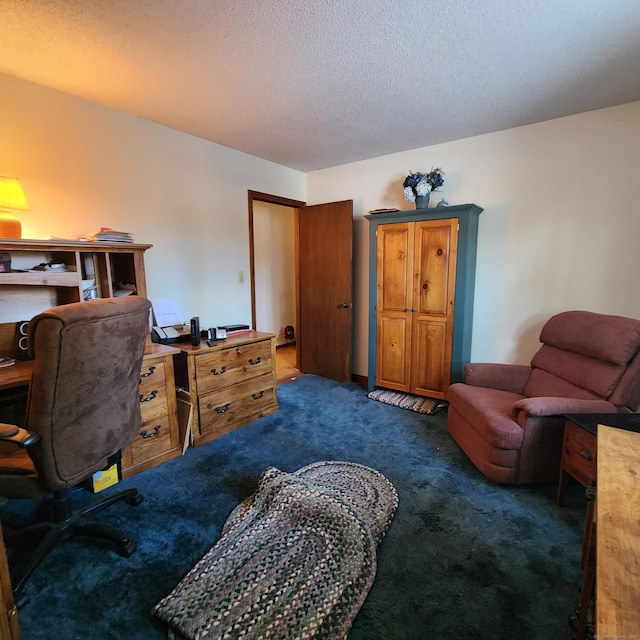 home office with a textured ceiling and dark colored carpet