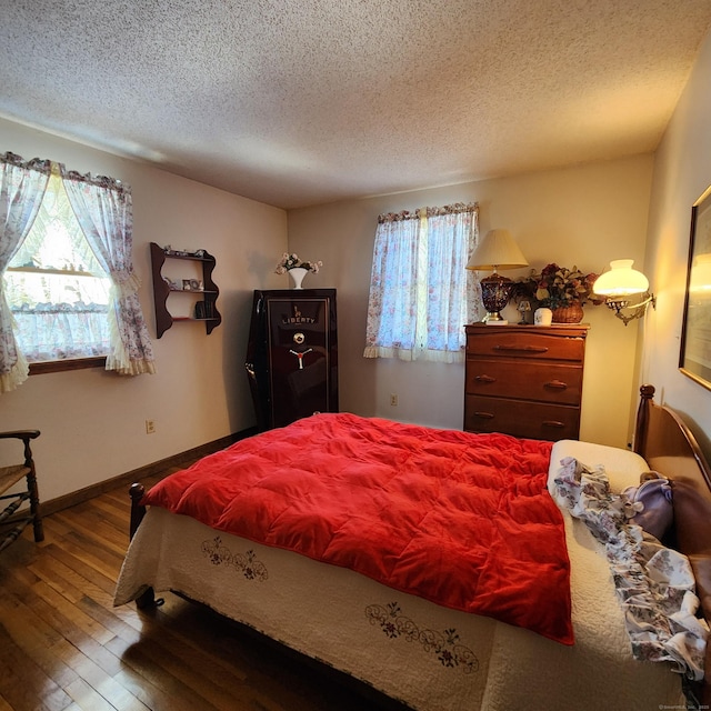 bedroom featuring hardwood / wood-style flooring and a textured ceiling