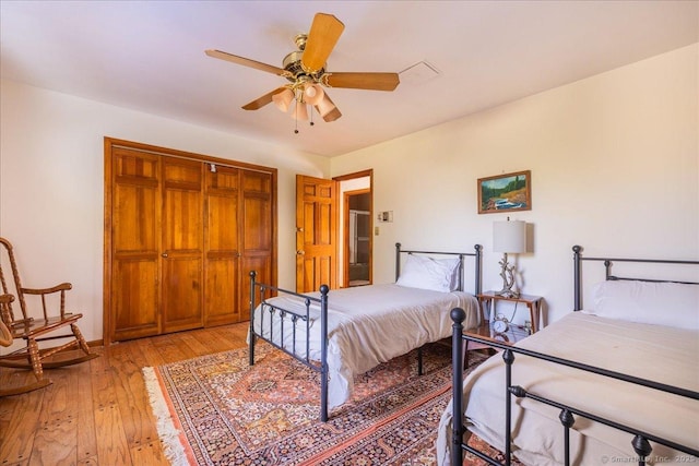 bedroom featuring light hardwood / wood-style flooring, a closet, and ceiling fan