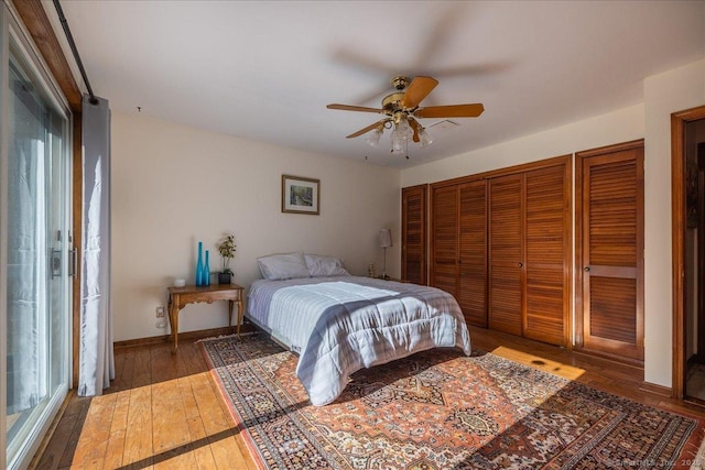 bedroom featuring dark wood-type flooring, ceiling fan, and a closet