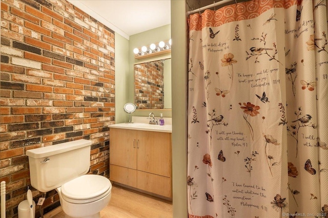 bathroom with hardwood / wood-style floors, vanity, brick wall, curtained shower, and toilet