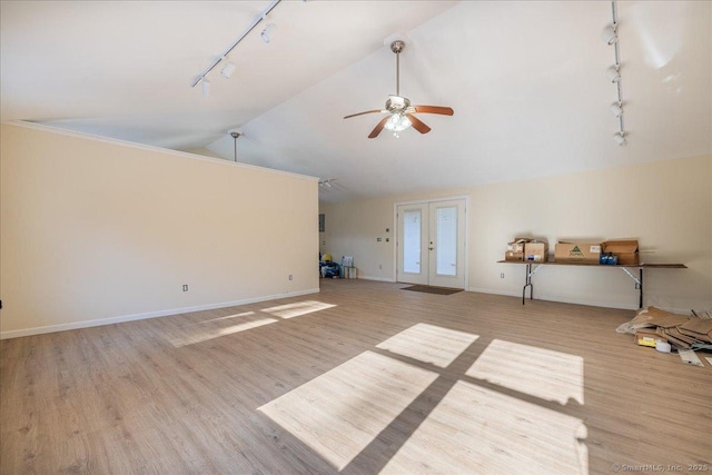 unfurnished living room featuring high vaulted ceiling, french doors, ceiling fan, track lighting, and light hardwood / wood-style flooring