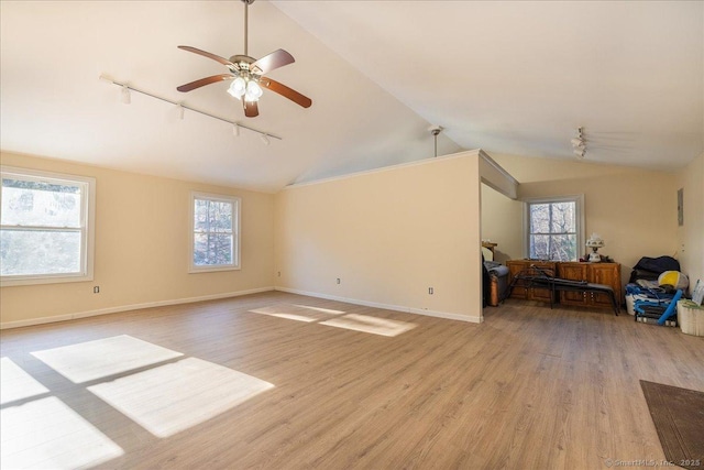 living room with vaulted ceiling, light hardwood / wood-style floors, rail lighting, and ceiling fan