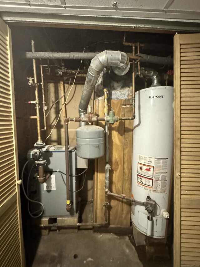 utility room featuring water heater