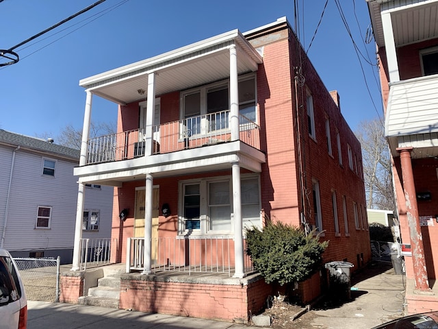 view of front of property with a balcony and covered porch