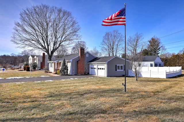 view of home's exterior with a yard and a garage