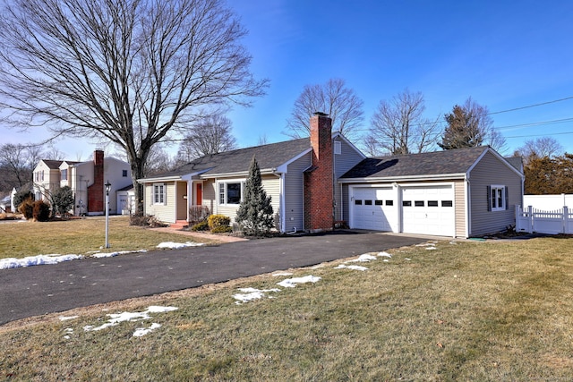 view of front of property featuring a garage and a front lawn