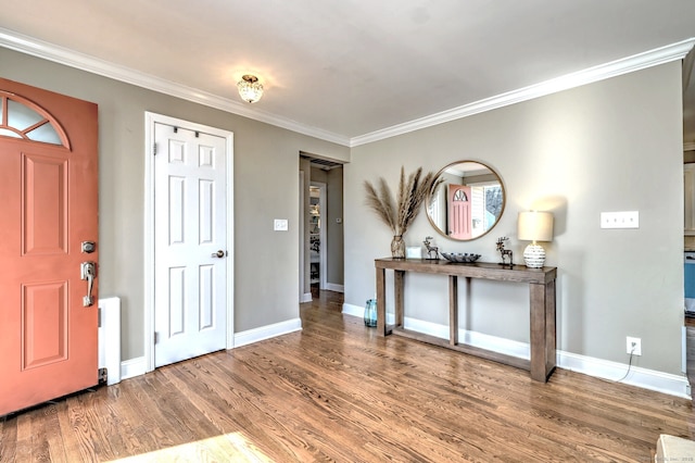 entrance foyer with ornamental molding and hardwood / wood-style floors