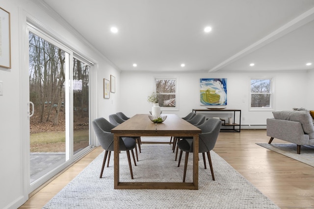 dining room with ornamental molding and light wood-type flooring