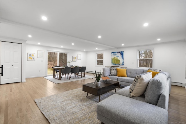 living room with a baseboard radiator and light wood-type flooring