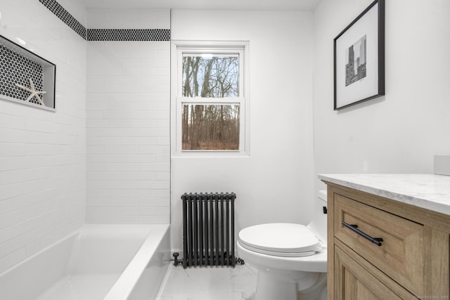 full bathroom featuring tiled shower / bath combo, toilet, radiator, and vanity