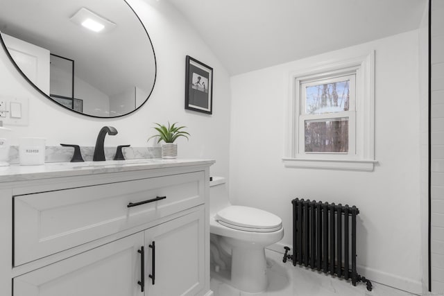 bathroom featuring radiator heating unit, toilet, vaulted ceiling, and vanity