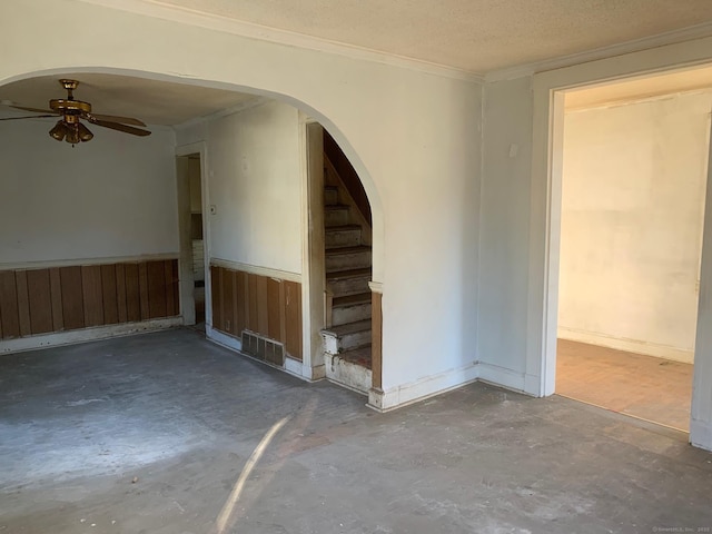 empty room featuring crown molding, ceiling fan, concrete floors, and a textured ceiling