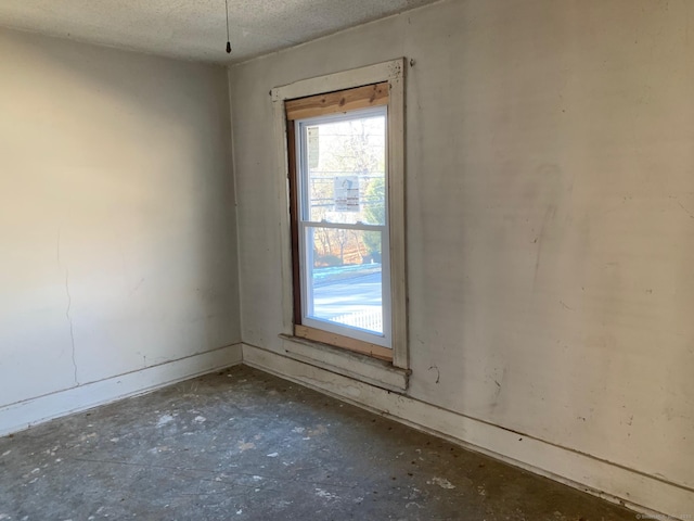 spare room with a textured ceiling