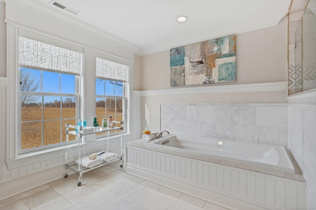 bathroom featuring a bath, ornamental molding, visible vents, and tile patterned floors