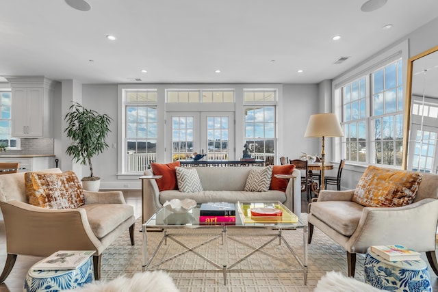 living room with french doors and light hardwood / wood-style floors