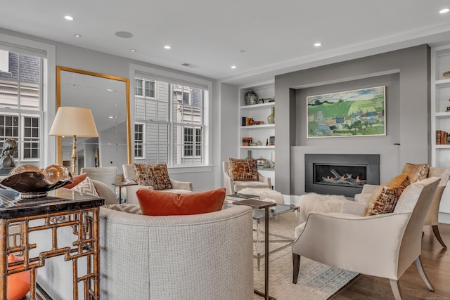 living room with hardwood / wood-style flooring and built in features