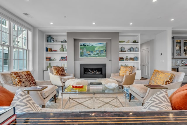 living room with built in shelves and indoor bar