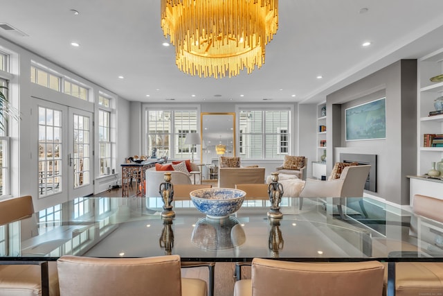 dining area featuring built in shelves and french doors