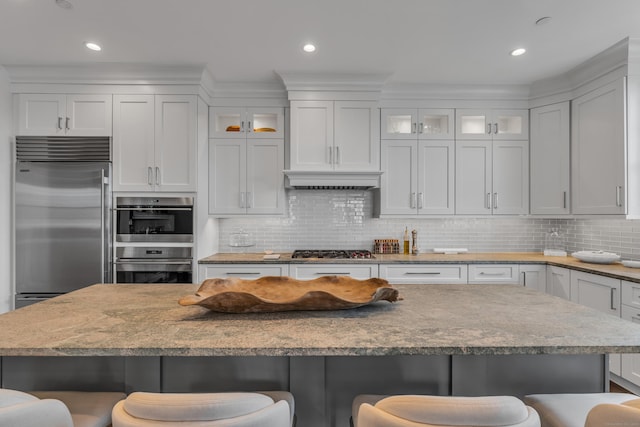 kitchen with a kitchen breakfast bar and white cabinets