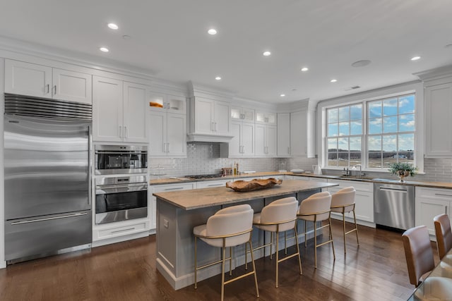 kitchen featuring stainless steel appliances, a center island, and white cabinets