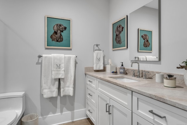 bathroom featuring vanity and toilet