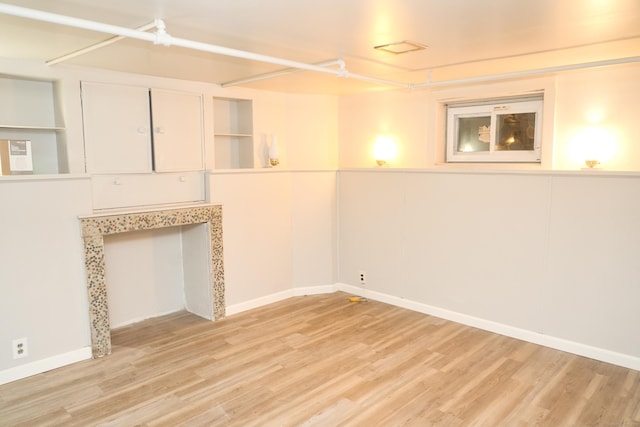 basement with light hardwood / wood-style floors