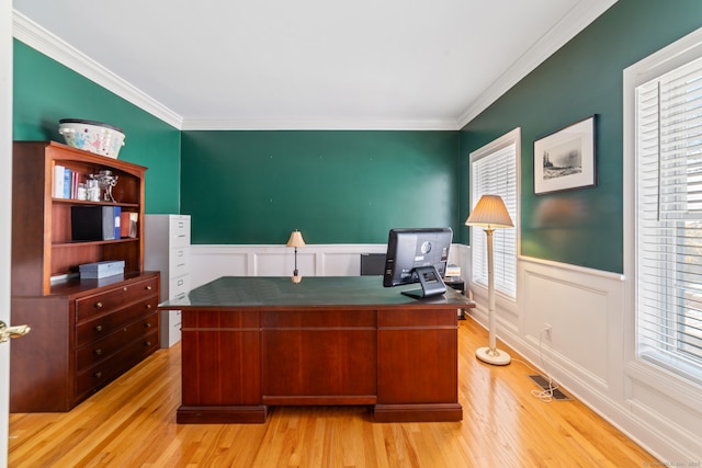 office featuring ornamental molding, wainscoting, and light wood finished floors