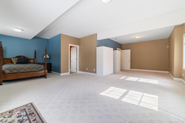 bedroom with baseboards and light colored carpet