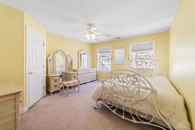 bedroom with ceiling fan, baseboards, visible vents, and light colored carpet