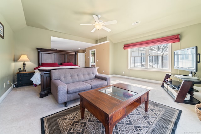 living area with visible vents, light carpet, vaulted ceiling, ceiling fan, and baseboards