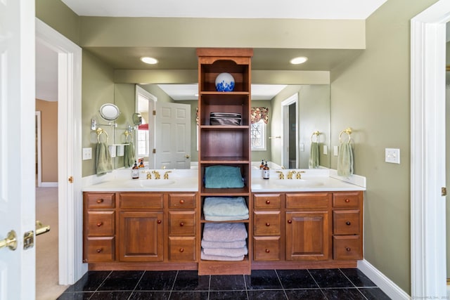 bathroom with recessed lighting, a sink, baseboards, and double vanity