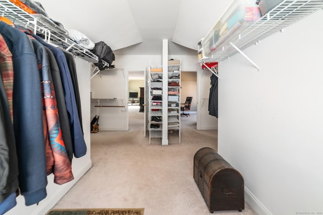 spacious closet with lofted ceiling and carpet flooring