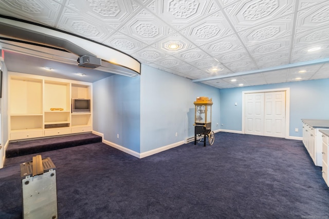 interior space featuring dark colored carpet, recessed lighting, and baseboards