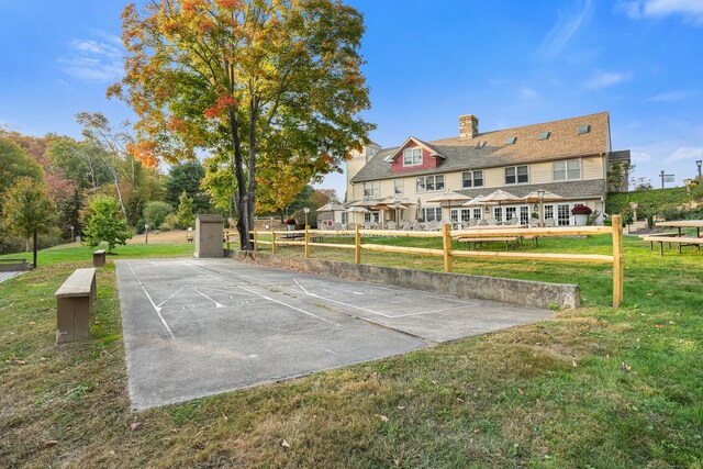 view of basketball court featuring a lawn