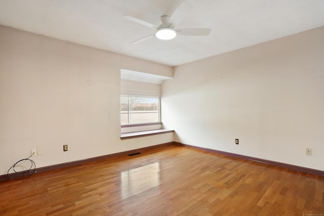 spare room featuring ceiling fan and light wood-type flooring