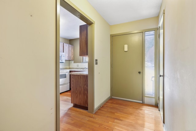 hall featuring sink and light hardwood / wood-style flooring