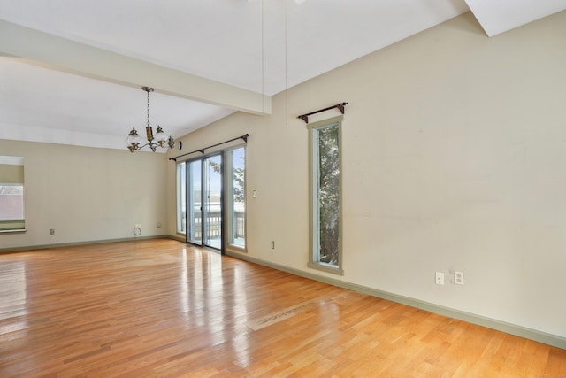 unfurnished room with beamed ceiling, an inviting chandelier, and light hardwood / wood-style floors