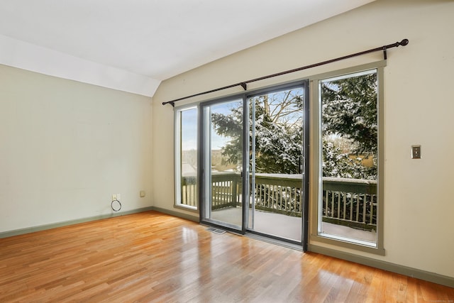 entryway featuring lofted ceiling and light hardwood / wood-style flooring