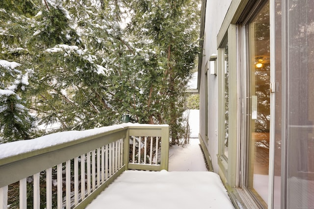 view of snow covered back of property