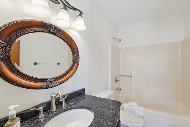 bathroom featuring toilet, bathtub / shower combination, and vanity