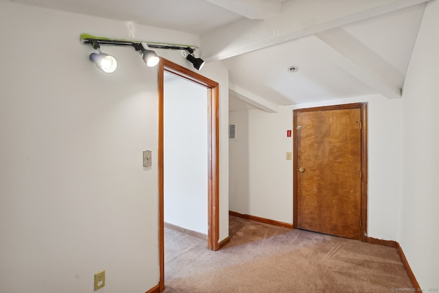 corridor featuring light colored carpet, vaulted ceiling with beams, visible vents, and baseboards