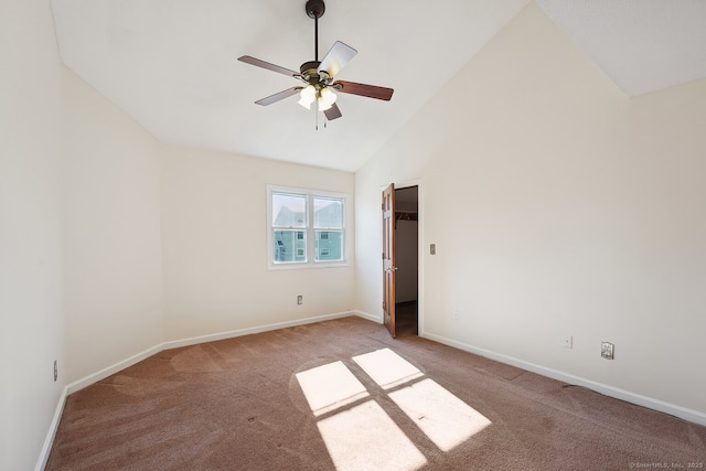 spare room with high vaulted ceiling, carpet, baseboards, and a ceiling fan