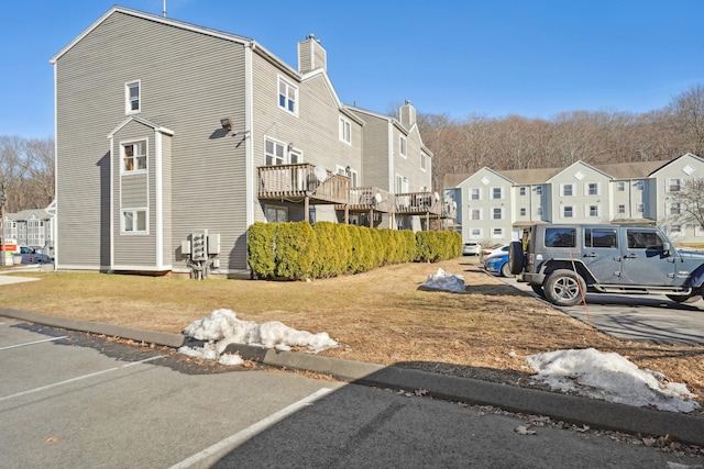 view of side of home with a residential view and a lawn