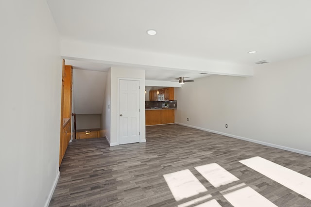 unfurnished living room featuring recessed lighting, visible vents, wood finished floors, beamed ceiling, and baseboards