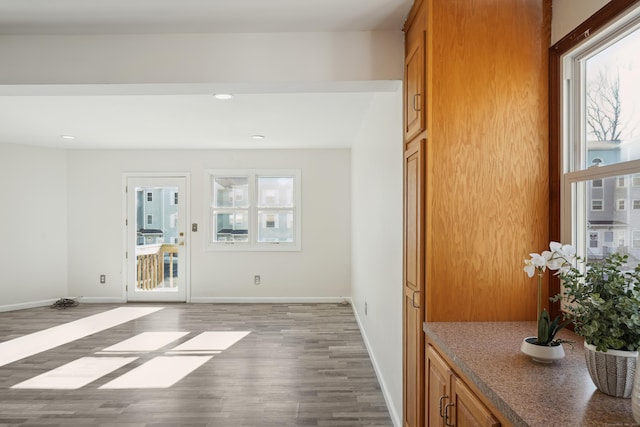 interior space with recessed lighting, wood finished floors, and baseboards