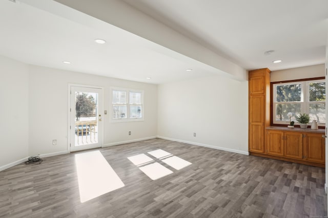 unfurnished room with recessed lighting, baseboards, and wood finished floors