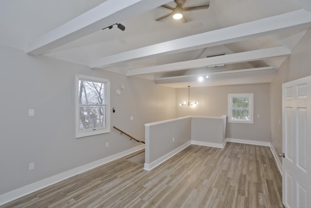 basement with ceiling fan and light hardwood / wood-style floors